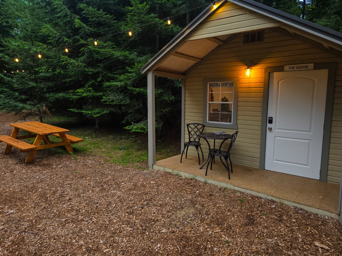 The Goose cabin at dusk with string lights