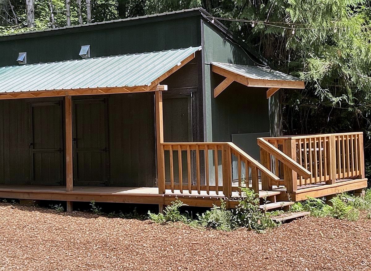 The shared bathhouse with its covered cedar deck and ramp